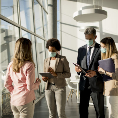 Group of multiethnic business people have a meeting and working in office while wear mask as protection from corona virus Group of multiethnic business people have a meeting and working in the office while wear mask as protection from corona virus